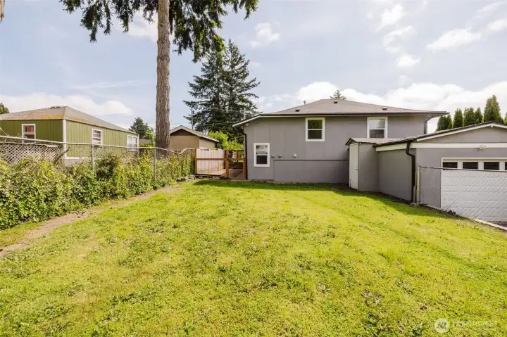 Huge yard with doorway access from garage space.