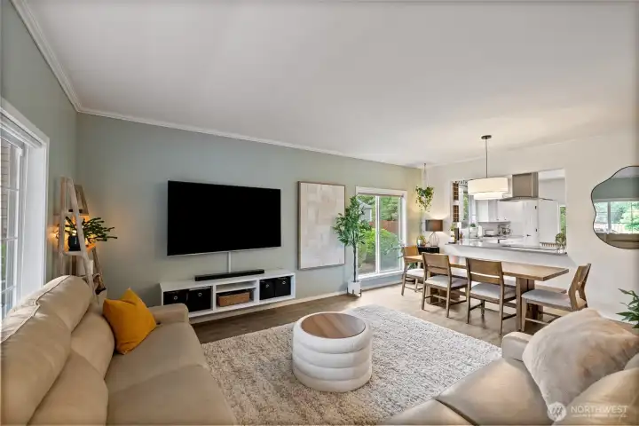 Located just off the entry, the light-filled family room features a custom built-in entertainment center and flows seamlessly into the dining room, creating an inviting space for gathering and everyday living.