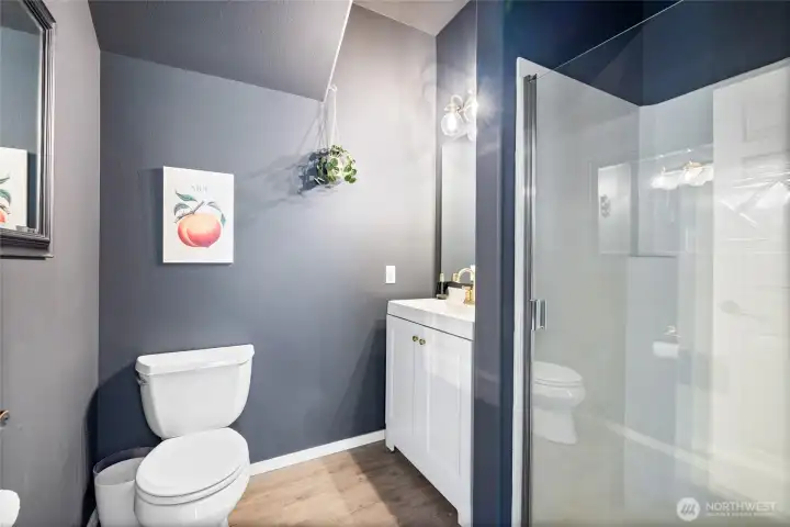 A thoughtfully placed main-floor ¾ bath provides added convenience for guests, home office use, and daily living.