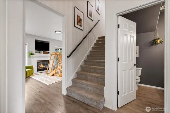 The staircase features newer carpet, a freshly painted railing, and a charming art niche—perfect for displaying artwork, photographs, or treasured décor.