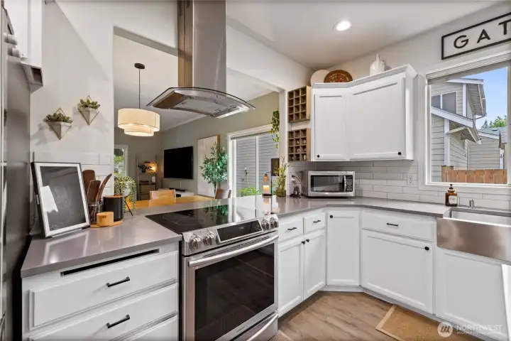 Upgraded stainless steel appliances provide modern convenience and complement the kitchen's clean, timeless design.