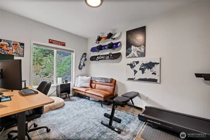 Conveniently located on the main level, this flexible bedroom adapts to your lifestyle, and oversized window allows light to pour in.