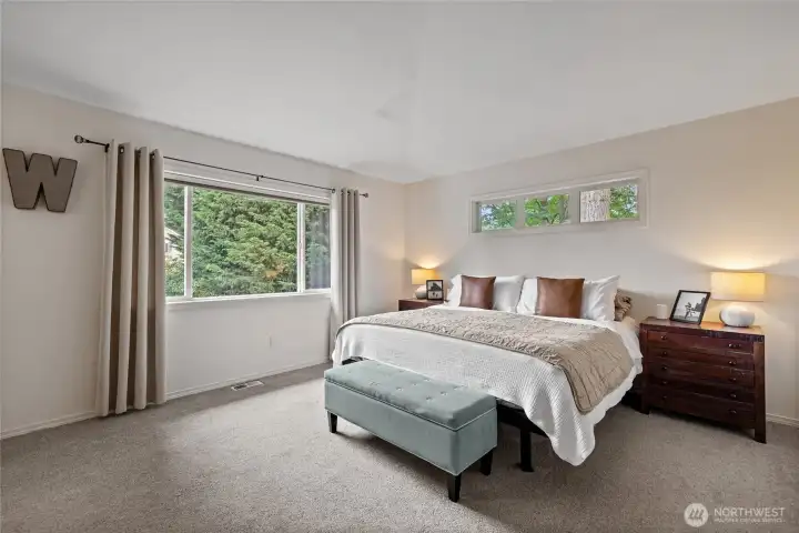 Wake up to tranquil views of the beautifully landscaped backyard from this light-filled and inviting primary suite.