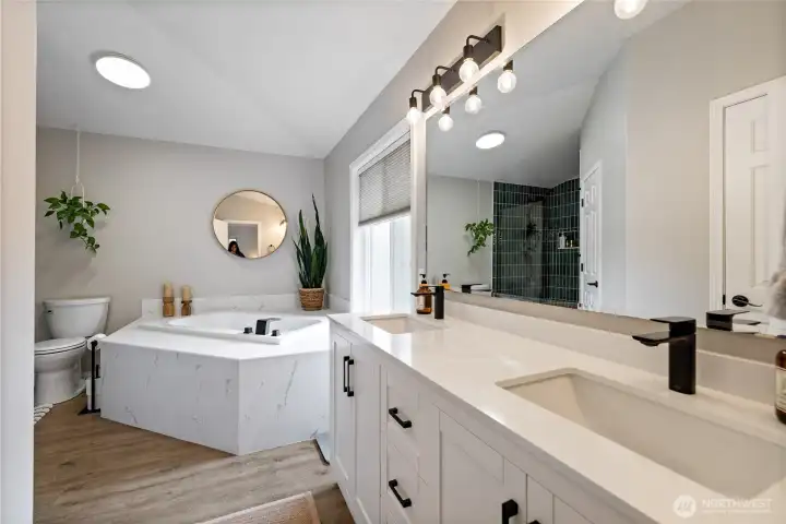 The spacious primary bath features dual sinks and abundant counter space, making busy mornings effortless.
