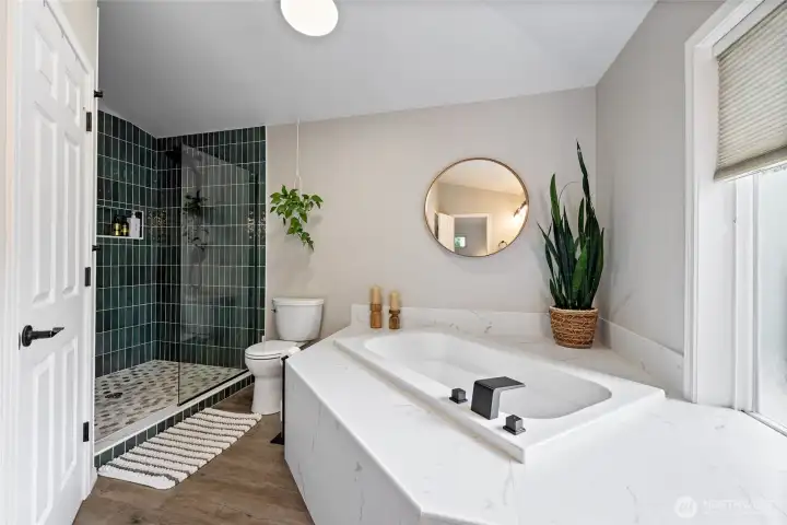 The remodeled primary bath blends modern finishes with everyday comfort.The beautifully updated custom tile shower features dual showerheads, offering a luxurious and refreshing experience.