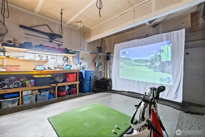 The oversized garage features an updated overhead door track system that eliminates the traditional center track, creating additional vertical clearance for taller vehicles, storage solutions, fitness equipment, or a golf simulator setup.