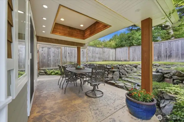 Covered Outdoor Seating has Coved Ceiling and Custom Can Lighting on a Stamped Concrete Patio