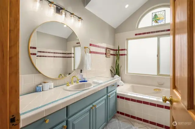 Fun primary bath with separate tub and shower! Light and bright.