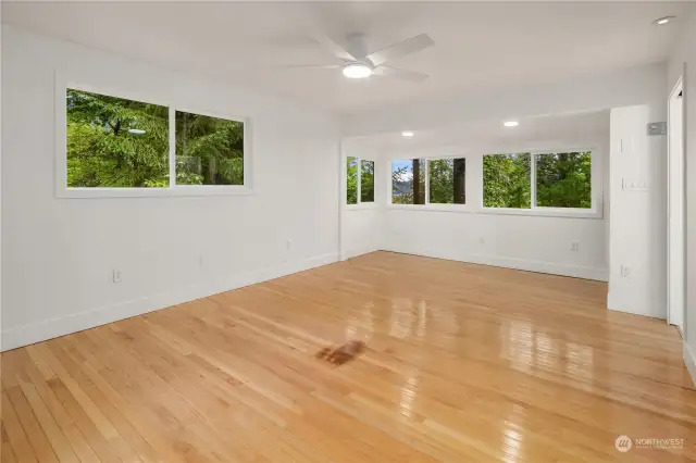 Another angle of the primary bedroom with wrap-around views provides a bright option for arranging furniture and capturing the water views morning or night from the sanctuary of your own room.