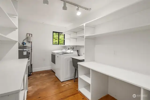 Yes please! The main floor laundry room is set for your extra storage needs! A utility sink for easy cleanup and a window for natural light and extra ventilation.  Brand new water heater both here and downstairs too. Just wonderful!