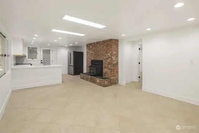 Stepping inside the lower level living room/family room space from the separate exterior French door entrance, imagine this space as a comfortable home for family members or extra income as a nightly rental!