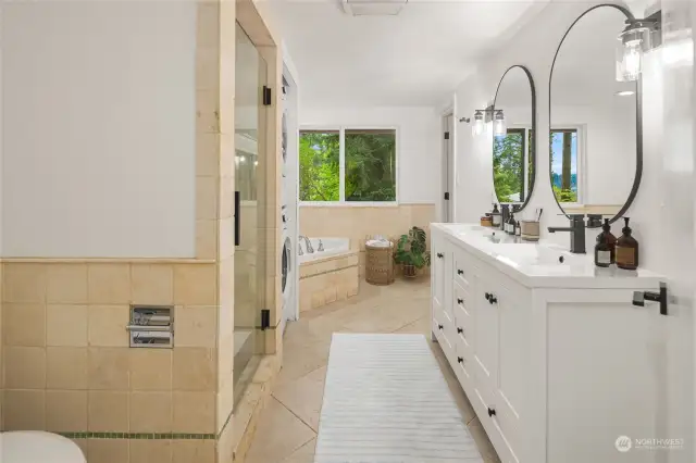 The downstairs bathroom offers a 2nd main-primary-suite vibe with this 5-piece bath.  The lower level includes another deep jetted soaking tub and a SECOND private laundry room setup!