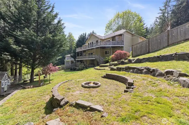 Fire pit in fully fenced backyard.