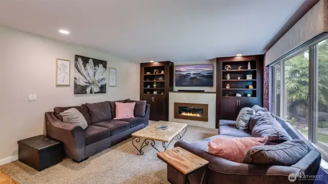 This trendy fireplace, framed by built-in shelves, adds both warmth and style to this living space