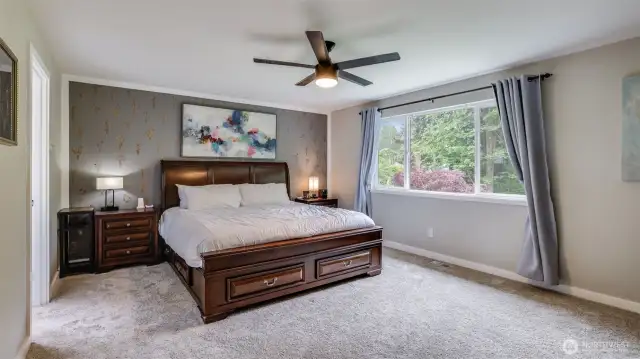 The primary suite boasts abundant natural light, generous room to relax, and private entry to the attached bathroom
