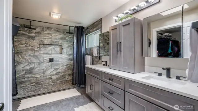 The ensuite bathroom boasts a stunning large walk-in shower with tile and quartz finishes, featuring a double-head shower for ultimate comfort. Plus, enjoy the convenience of a nearby spacious walk-in closet