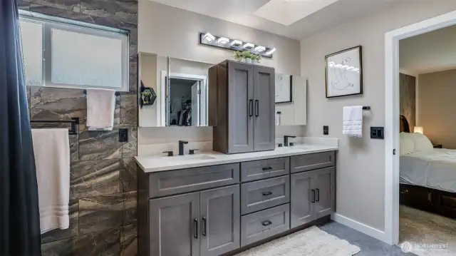 Modern en suite bathroom featuring a double vanity, ample cabinet storage, and plenty of space for your essentials