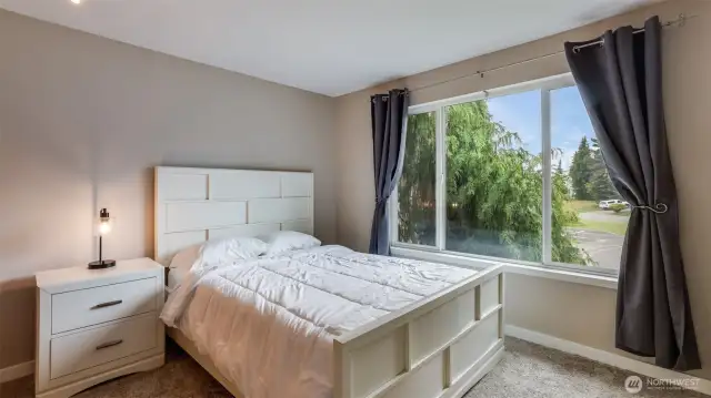 Comfortable guest bedroom with great natural lighting, ready to welcome all of your guests!