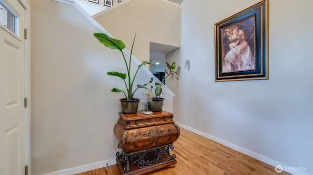 Step into these gleaming hardwood floors that flow seamlessly through an open-concept layout, with direct access to the upstairs retreat!