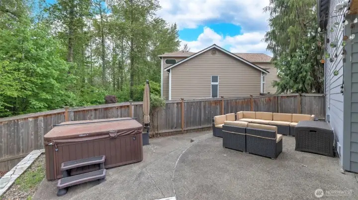 Relax and unwind—the hot tub and outdoor seating stay, with plenty of room for even more seating to enjoy the outdoors