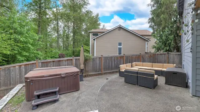 Relax and unwind—the hot tub and outdoor seating stay, with plenty of room for even more seating to enjoy the outdoors