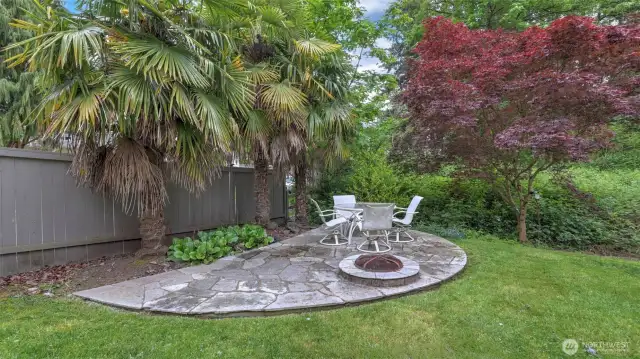 A generous, separate concrete area in the backyard, perfect for seating and cozy nights around the fire pit
