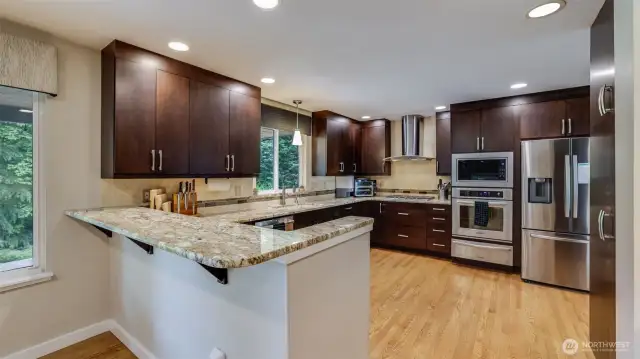 This kitchen is complemented by a cozy dining nook on the side, perfect for quick meals or casual gatherings