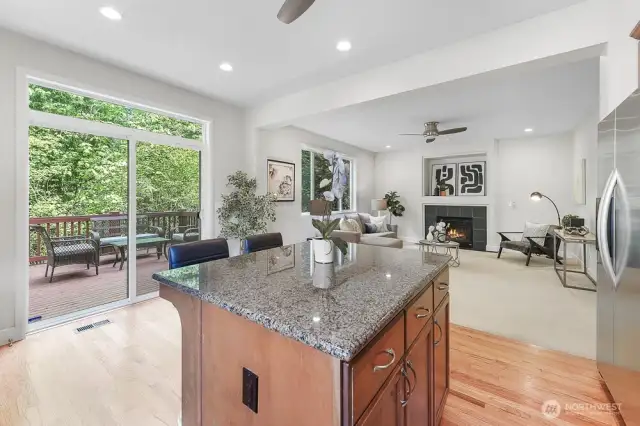 The kitchen features granite countertops, stainless steel appliances, and high ceilings.