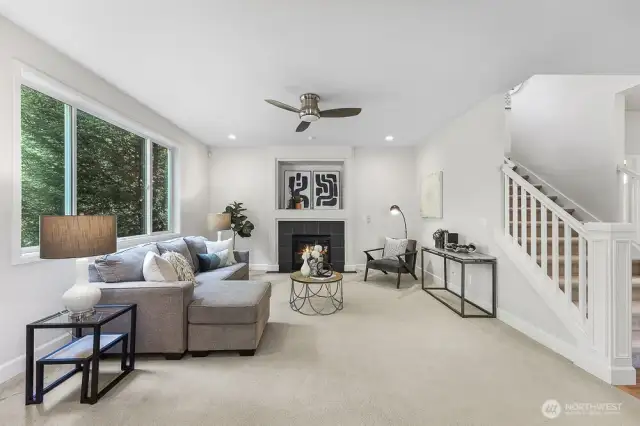 Just off the kitchen is the family room with a gas fireplace and a large window looking out to the greenbelt.