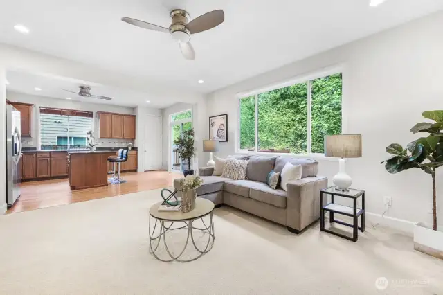 Just off the kitchen is the family room with a gas fireplace and a large window looking out to the greenbelt.