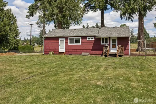 Back view of this cutie. Roof is pretty recent and in great shape. Sweet little back deck and strawberries on the side too!
