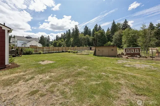 Chicken pen near the back deck and a raised bed already has veggies growing in it for you.