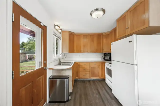 Cute little efficient kitchen with door to the back deck.