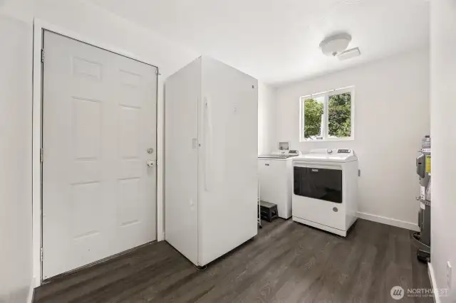 Utility room is extra big with some good usable space. Door leads to back yard.
