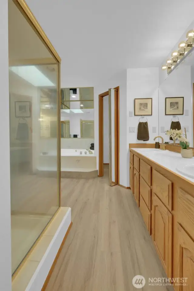 Primary bathroom with dual sink vanity, large shower, jetted soaking tub &  2 walk-in closets.