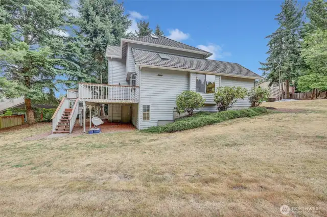 Huge yard w/ stairs from deck leading to backyard. Door accesses the basement