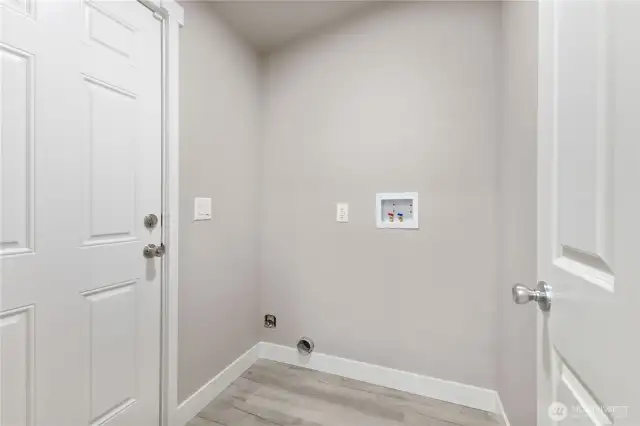 Utility room with a door that leads to the backyard