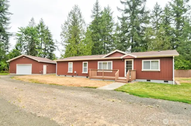 Front view of this 3 bedroom 2 bath with den home and shop