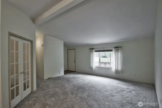 Looking from the spacious kitchen towards the living room and entry