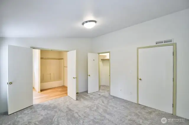 View in the primary suite with double doors opening into the spacious primary bath