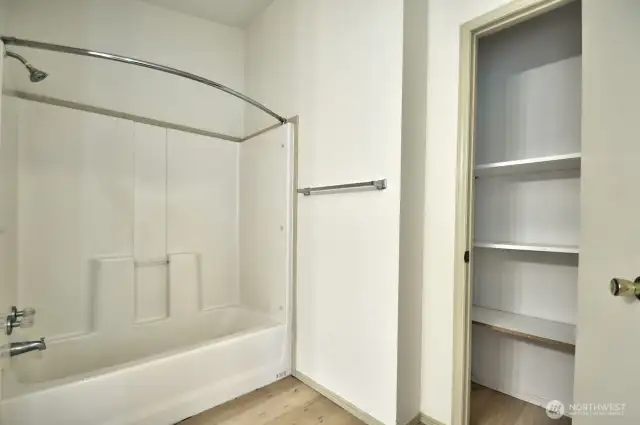 Another view of the primary bathroom with linen closet