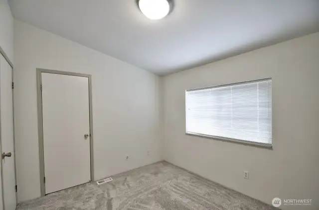 2nd bedroom with nice sized closet and view of mature trees out the window