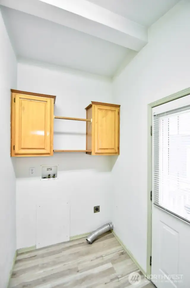 Big laundry room with  room for a freezer and a back door to the shop