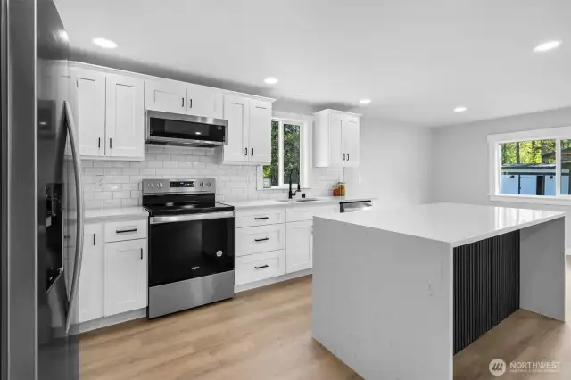 Sylish Quartz Counters and Island w/ Waterfall Edge