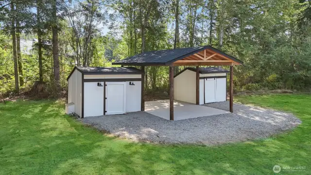Carport flanked by sheds offering space for your storage needs.