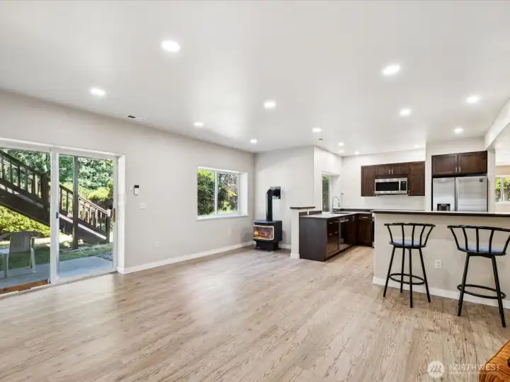 Lower level entry.  New LVP flooring and a fireplace and high ceilings.