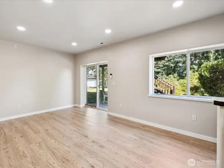 Lower level with private entrance, high ceilings, and new engineered hardwoods (LVP).