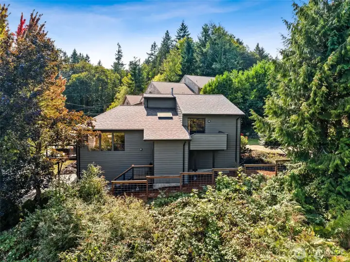 The dynamic design of this architecturally inspiring home incorporates a large, two car, lower garage, with extra storage,a mid-level great room/kitchen and deck area, all topped by bedroom spaces, with a deck off the primary. suite.