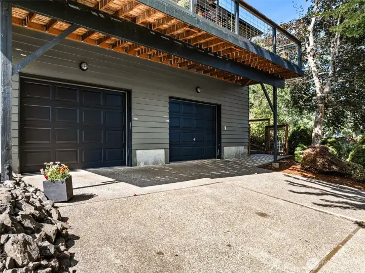 The parking area in front of the home, leads to the front door entrance at the upper right of the photo.