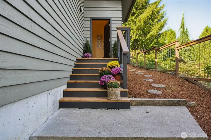 The recently replaced front entry, lends a contemporary touch to the home. The wide stairway and large landing, leave extra space for your holiday decor.  Welcome!